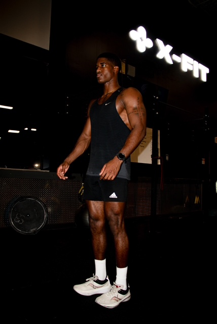 Personal trainer coaching client during in-person strength training session